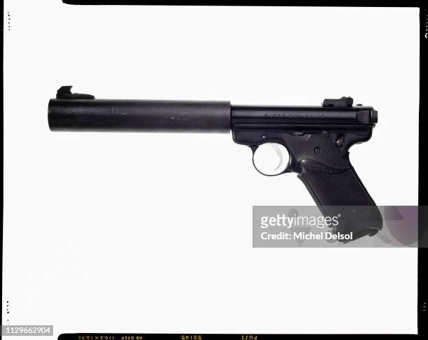 Left profile of a Ruger Mark II semi-automatic pistol with an attached silencer, seen against a white background, New York, New York, February 2,...