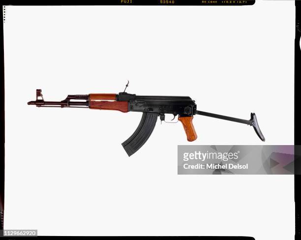 Left profile of an AKM assault rifle with an attached magazine, seen against a white background, New York, New York, March 9, 1994. The photo was...