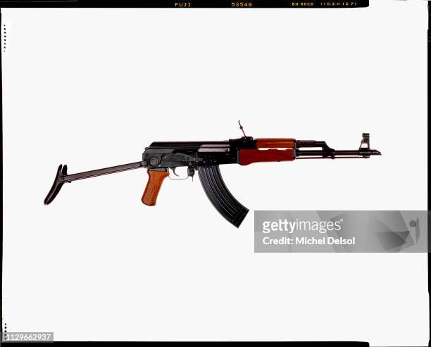Right profile of an AKM assault rifle with an attached magazine, seen against a white background, New York, New York, March 9, 1994. The photo was...