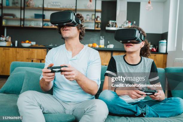 father and son playing with vr - watching parents fight stock pictures, royalty-free photos & images