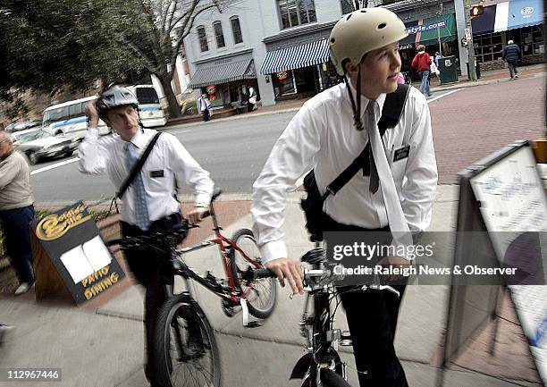 Church of Jesus Christ of Latter Day Saints missionary elders Jody Zimmer left, and Patrick Loftus walk their bikes along Franklin Street, November...