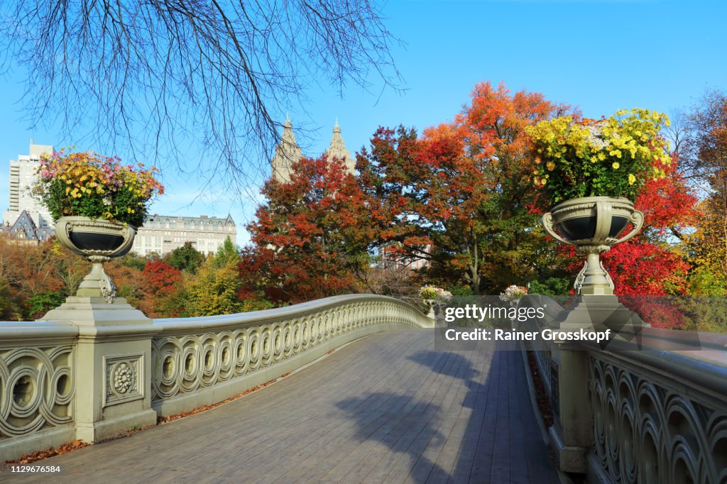 Bow Bridge decorated with flower pots in Autumn