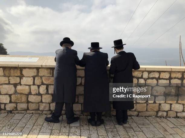 Three Ultra Orthodox Jews pray at a wall on February 7, 2019 in Safed , Israel.