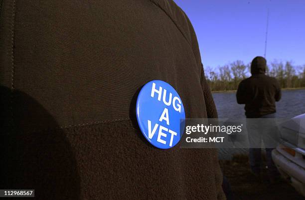 Lance Cpl. Brandon Sheppard sports a button on his jacket during the Wounded Warriors fishing trip hosted by the Cape Lookout Flyfishers at Lilly+=s...