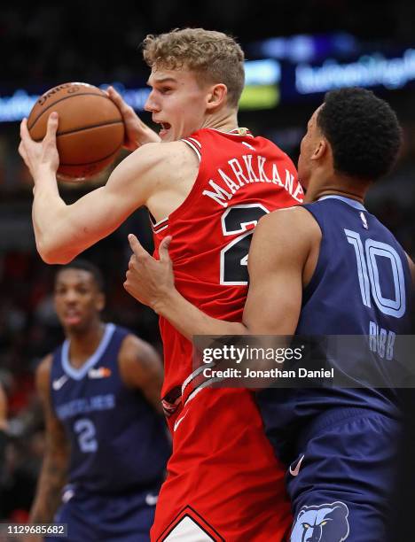 Lauri Markkanen of the Chicago Bulls moves against Ivan Rabb of the Memphis Grizzlies at the United Center on February 13, 2019 in Chicago, Illinois....