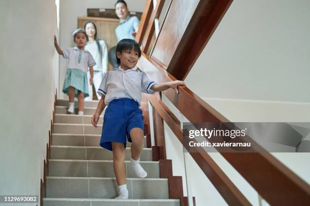 smiling boy with family on steps at home - kid looking down stock pictures, royalty-free photos & images