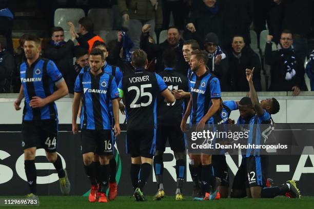 Club Brugge players celebrate after Stefano Denswil of Club Brugge scored his team's first goal during the UEFA Europa League Round of 32 First Leg...