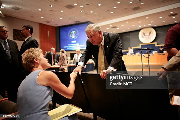 Chairman Mark Rosenker greets Amy Clay, the wife of pilot Jeff Clay during a break in an NTSB meeting on the Lexington, Kentucky crash investigation...