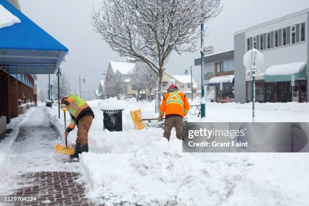 city workers shovelling snow - strip stock pictures, royalty-free photos & images