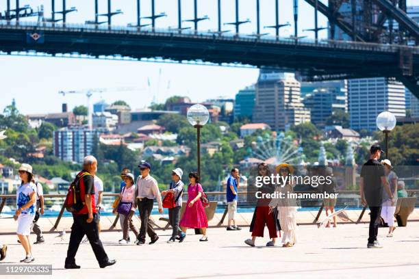 city street with tourists and holiday makers enjoying suny day - australia chinese stock pictures, royalty-free photos & images