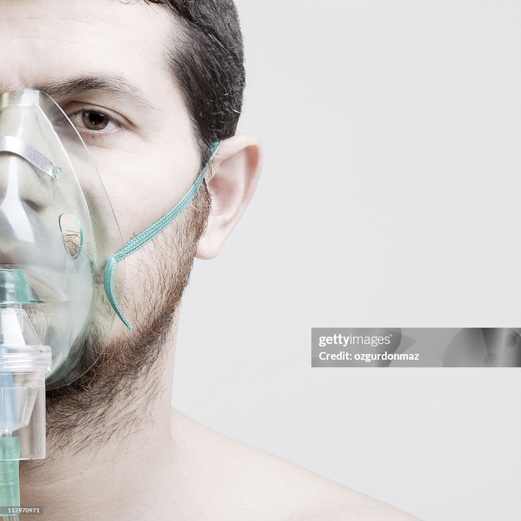 Young man with oxygen mask