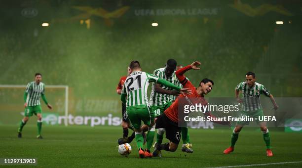 Benjamin Andre of Rennes is challenged by Giovani Lo Celso of Betis during the UEFA Europa League Round of 32 First Leg match between Stade Rennais...