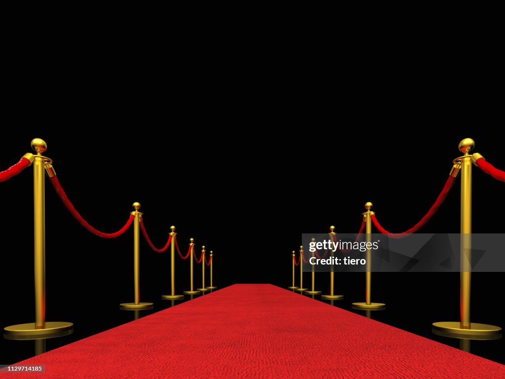 Red Carpet Event Amidst Bollards Against Black Background