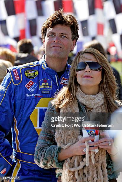 Driver Michael Waltrip and his wife Buffy watch the pre-race show before the NASCAR Nextel Cup Daytona 500 at Daytona International Speedway in...