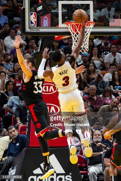 Miami Heat guard Dwyane Wade scores against Toronto Raptors center Marc Gasol in the fourth quarter on Sunday, March 10, 2019 at the AmericanAirlines...