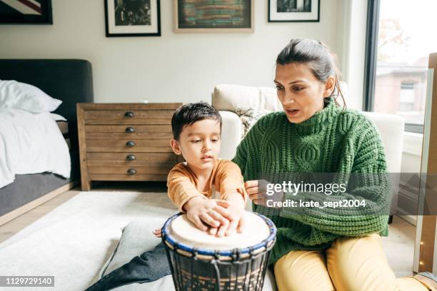 toddlers: learning by playing - indian drums stock pictures, royalty-free photos & images