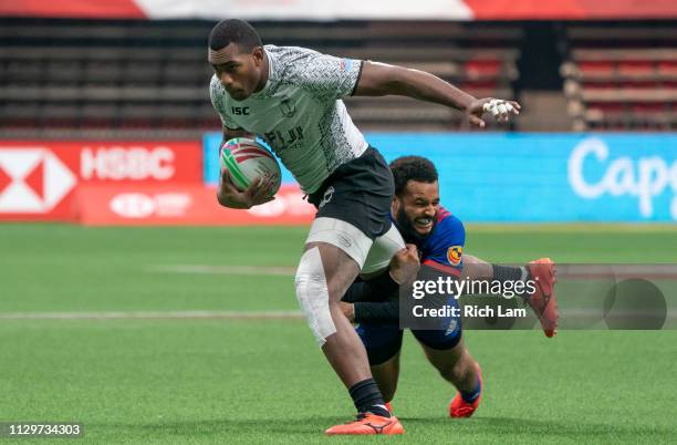 Mesulame Kunavula of Fiji tries to break free from the tackle of Maceo Brown of the United States during the bronze medal game on Day 2 of the HSBC...