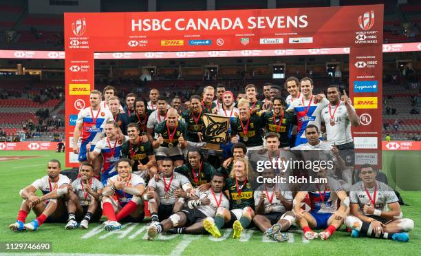 Champions South Africa poses for a photo with second place France and third place Fiji at the conclusion of the HSBC Canada Sevens at BC Place on...