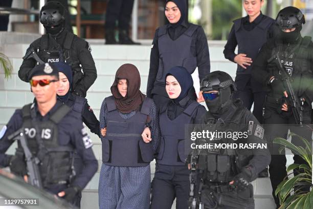 Vietnamese national Doan Thi Huong is escorted by Malaysian police after a hearing at the Shah Alam High Court, outside Kuala Lumpur on March 11,...