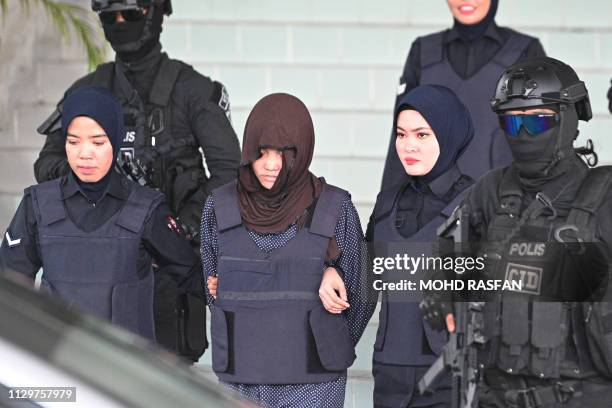 Vietnamese national Doan Thi Huong is escorted by Malaysian police after a hearing at the Shah Alam High Court, outside Kuala Lumpur on March 11,...