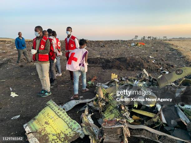 March 10, 2019 -- Rescuers work beside the wreckage of an Ethiopian Airlines' aircraft at the crash site, some 50 km east of Addis Ababa, capital of...