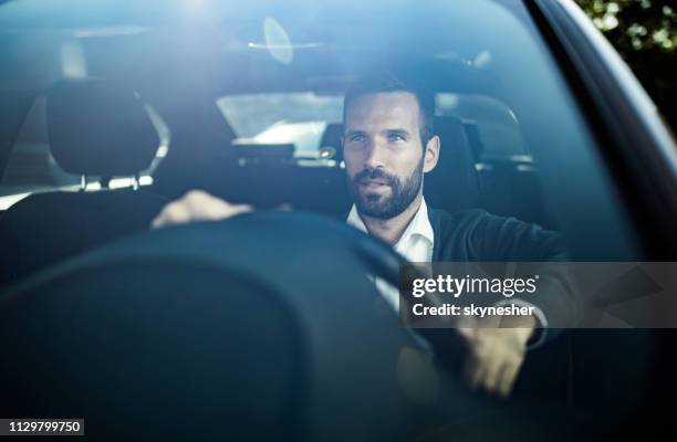 jonge zakenman besturen van een auto tijdens woon-werkverkeer te werken. - business person driving stockfoto's en -beelden