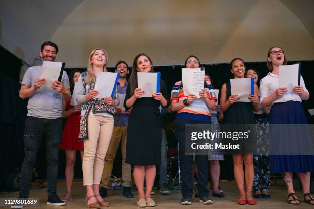 multi-ethnic people singing at choir practice in school - choir stage stock pictures, royalty-free photos & images