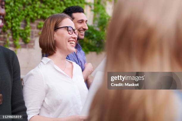 smiling young woman with friends singing in choir outside language school - psalm bildbanksfoton och bilder