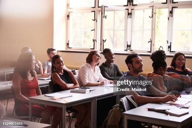 multi-ethnic students learning language in classroom - student visa stockfoto's en -beelden