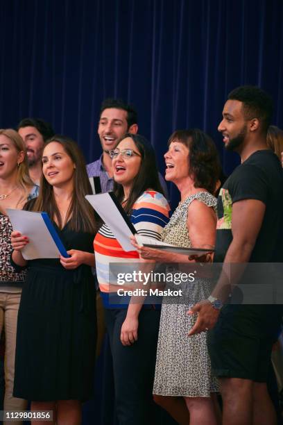 multi-ethnic people singing in choir on school stage - choir stage stock pictures, royalty-free photos & images