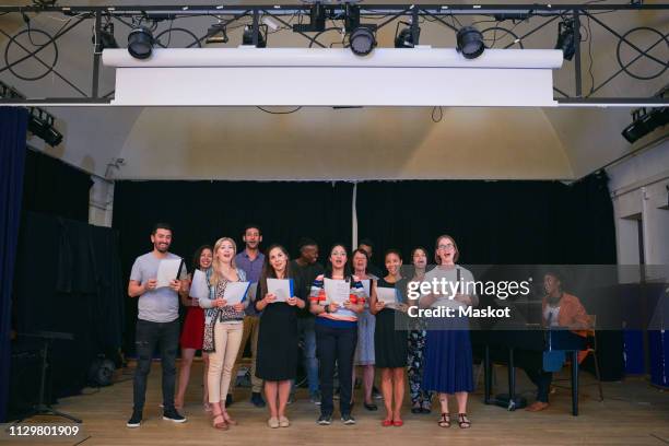choir members performing on stage in school auditorium - singing rehearsal stock pictures, royalty-free photos & images