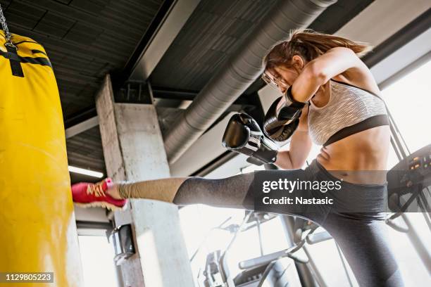 young woman training kickboxing ,high kick punch - karate woman stock pictures, royalty-free photos & images