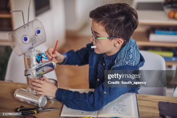 boy making robot for school project - kid creativity stock pictures, royalty-free photos & images