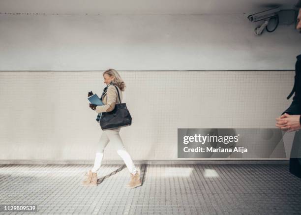 mature woman using subway to get to work - subway station ストックフォトと画像