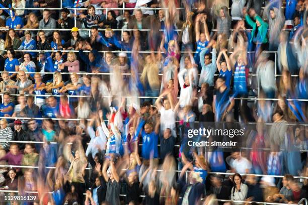 group of spectators cheering in stadium - enthusiastic crowd cheering and doing the wave stock pictures, royalty-free photos & images