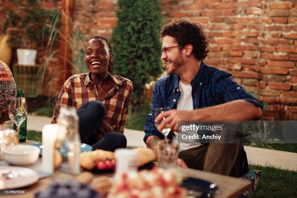 Millennials enjoying dinner in outdoor restaurant