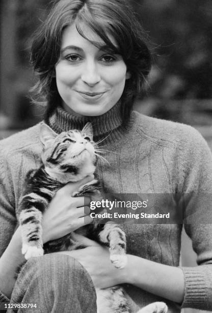 American actress, director, producer, author, and fashion model Anjelica Huston holding a cat, UK, 21st October 1968.