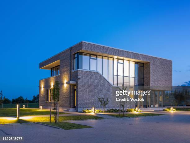 exterior of the office building in germany - office building entrance night stock pictures, royalty-free photos & images