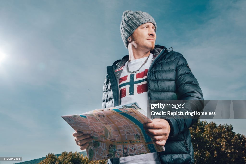 A tourist holds a map at hand and looks for directions