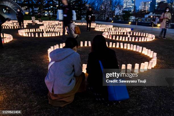 People take part during the candlelight vigil in Tokyo Midtown on March 11, 2019 in Tokyo, Japan. It is the 8th anniversary of the magnitude-9...