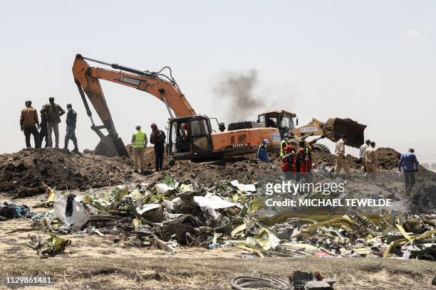 Power shovel digs at the crash site of Ethiopia Airlines near Bishoftu, a town some 60 kilometres southeast of Addis Ababa, Ethiopia, on March 11,...