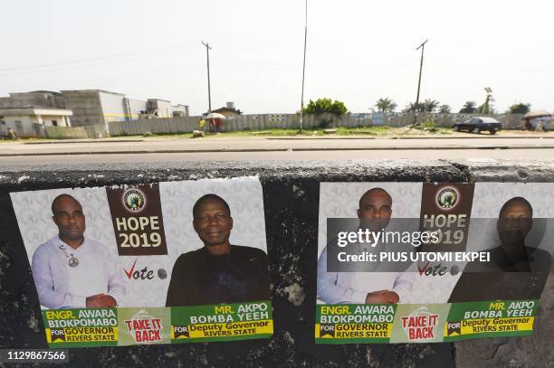 Picture taken in Port Harcourt, Rivers State, on March 11, 2019 shows campaign posters of gubernatorial candidate of African Action Congress , Awara...