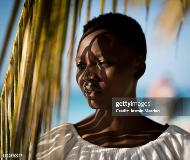 beautiful girl on under palm tree - palm tree lights stock pictures, royalty-free photos & images