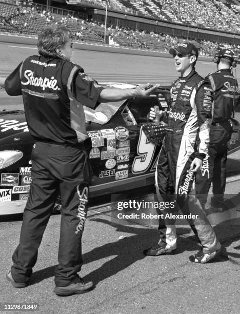 Stock car driver Kurt Busch talks with a member of his crew prior to the start of the 2005 Daytona 500 at Daytona International Speedway in Daytona...