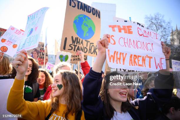 Students holds up their placards as they gather in Parliament Square during a climate protest on February 15, 2019 in London, United Kingdom....