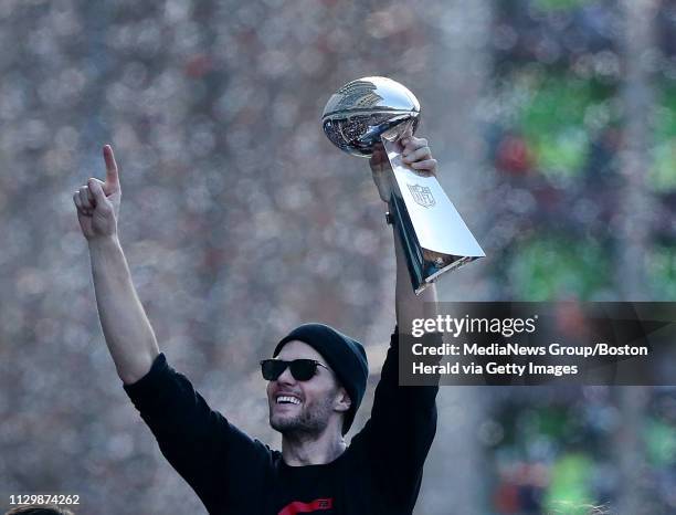 Tom Brady of the New England Patriots celebrates with the Lombardi trophy during the team victory parade after winning Super Bowl LIII on February 5,...