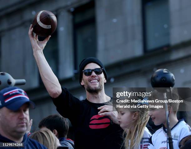 Tom Brady of the New England Patriots tosses a football to the crowd during the team victory parade after winning Super Bowl LIII on February 5, 2019...