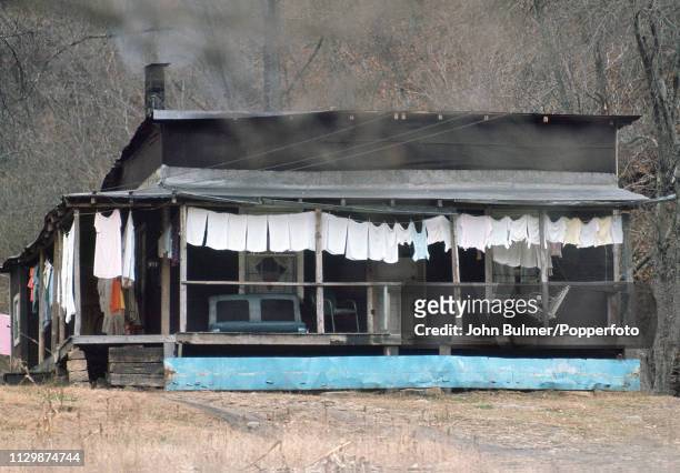 Log house with laundry hanging under the porch, Pike County, Kentucky, US, 1967.