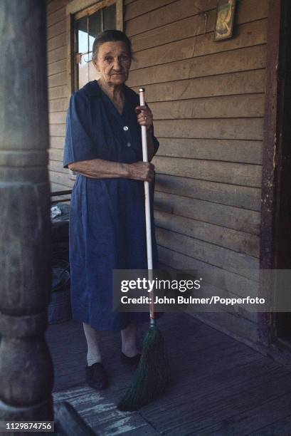 An elderly woman with a broom, Pike County, Kentucky, US, 1967.