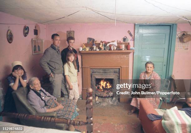 Family in their living room near a open coal fireplace, Pike County, Kentucky, US, 1967.